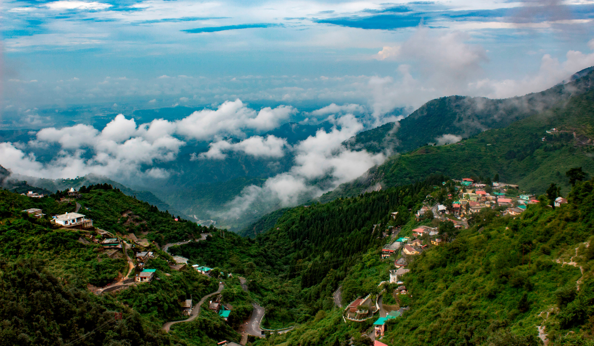 Mall Road Mussoorie with shops, cafes, and tourists walking.
